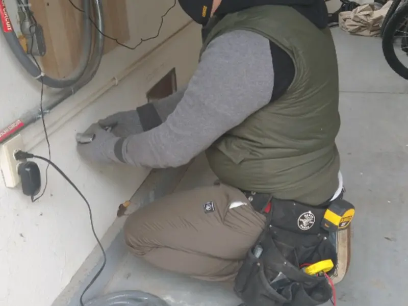 Electrician performing outlet wiring in a Granite Bay garage